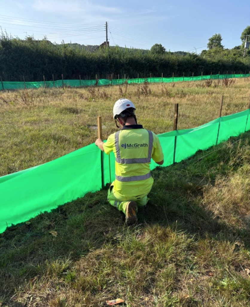EJ McGrath installing environmental silt fencing on site