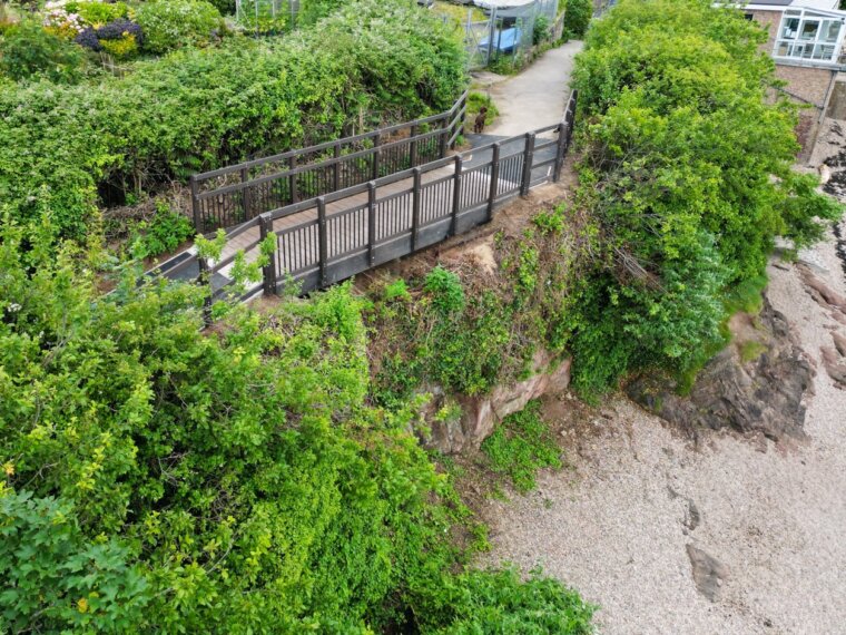 New FRP footbridge at Portishead Yacht and Boat Club seen from above, on the coastal path above Sugar Loaf Beach