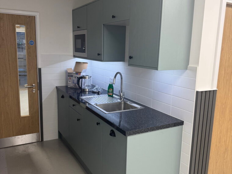 New kitchen fit-out with integrated appliances and stainless sink