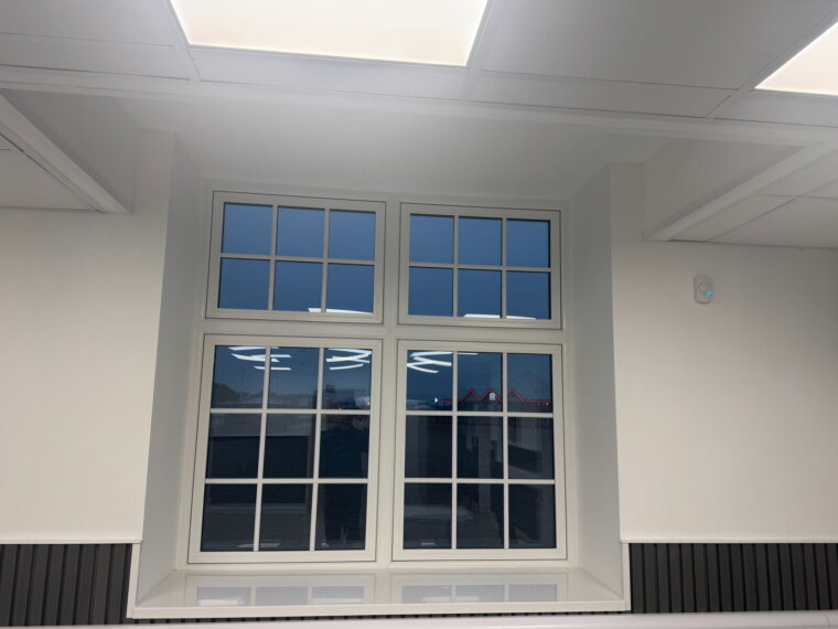 White UPVC double-glazed windows matched to the originals